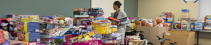 Woman organizing table full of donated toys
