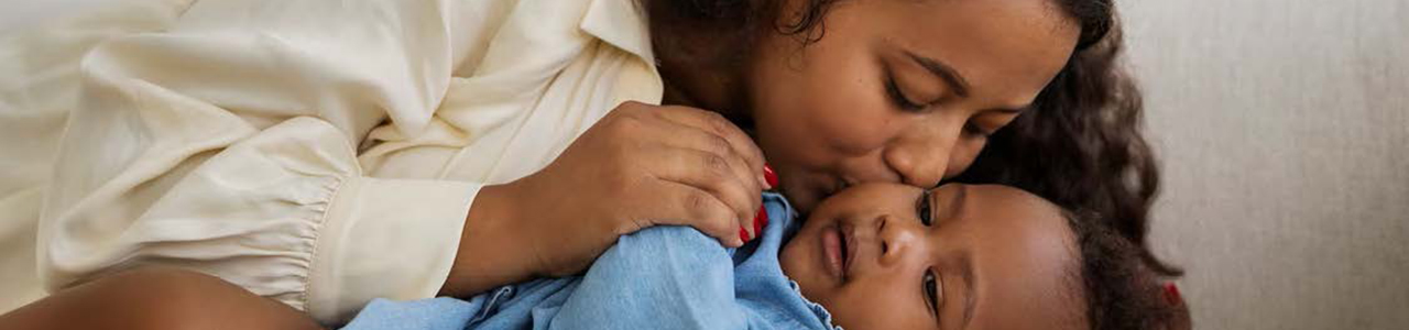 Mother kissing babies cheek