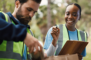 Clipboard, outdoor or volunteer people with paper bag, community service or packaging for charity drive.